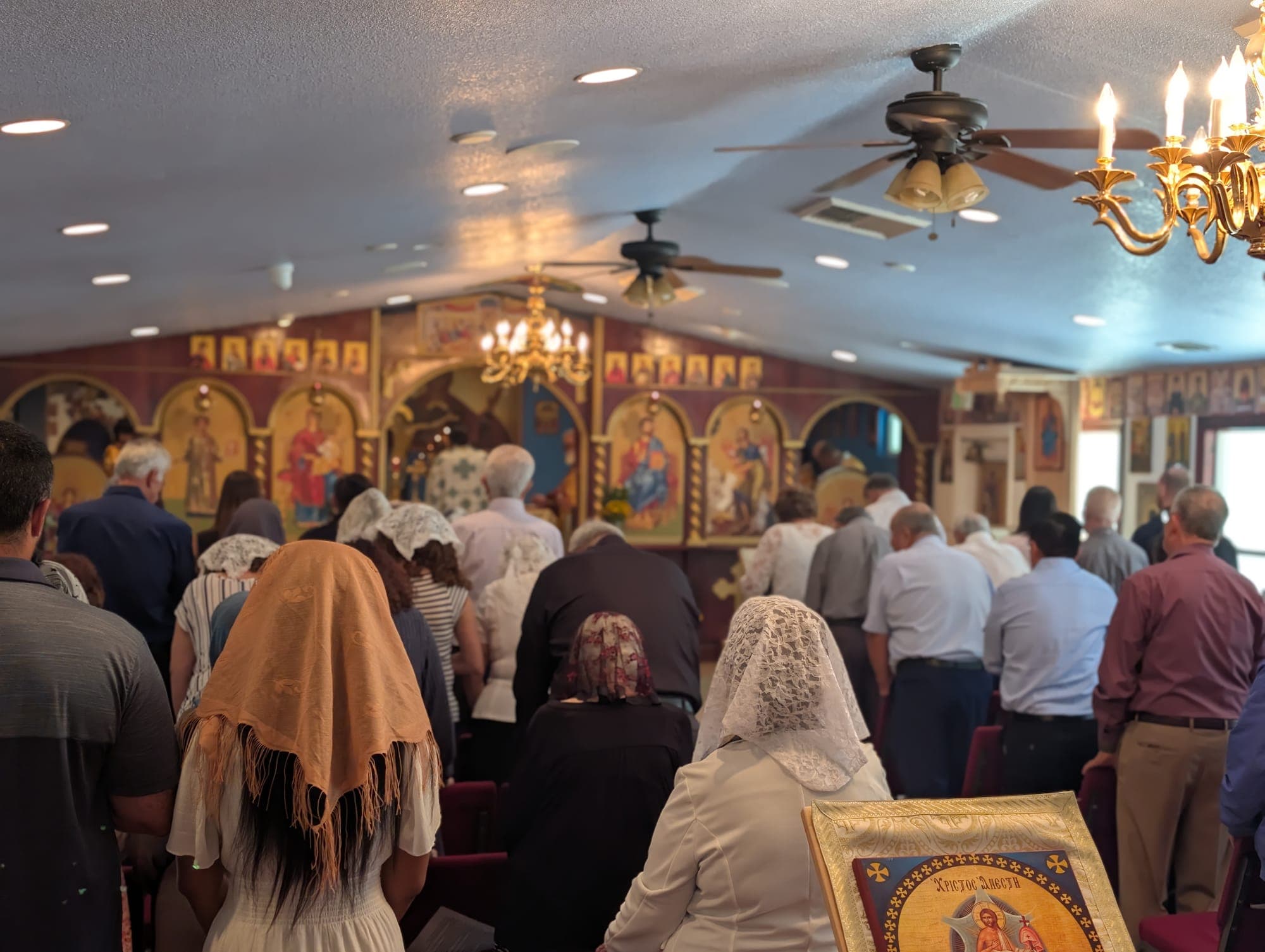The faithful gathered in the nave facing the iconostasis
