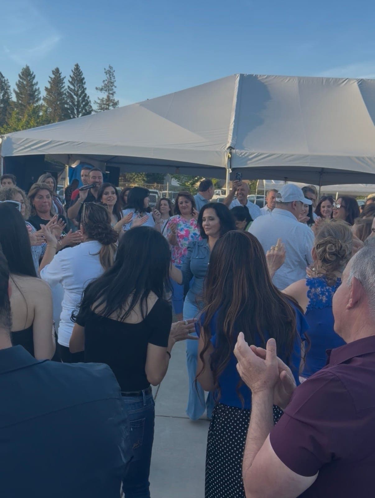 The crowd gathered and clapping under the tent