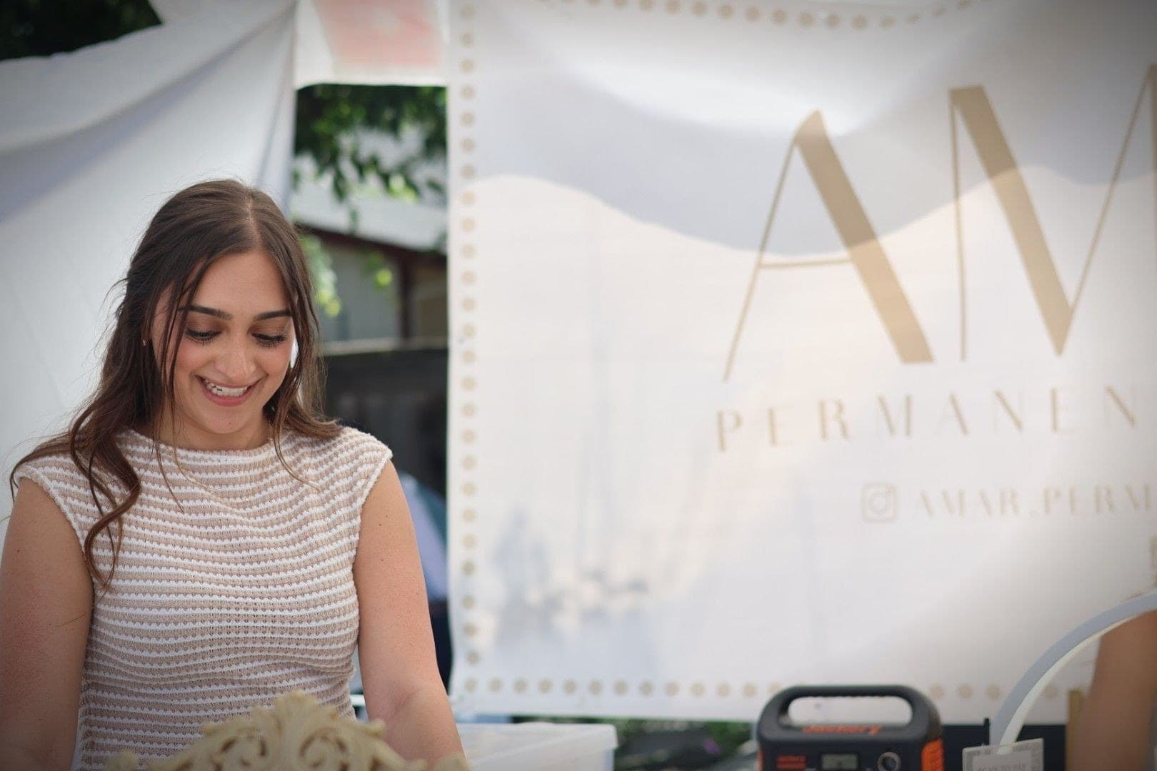 A vendor at the permanent-jewelry booth