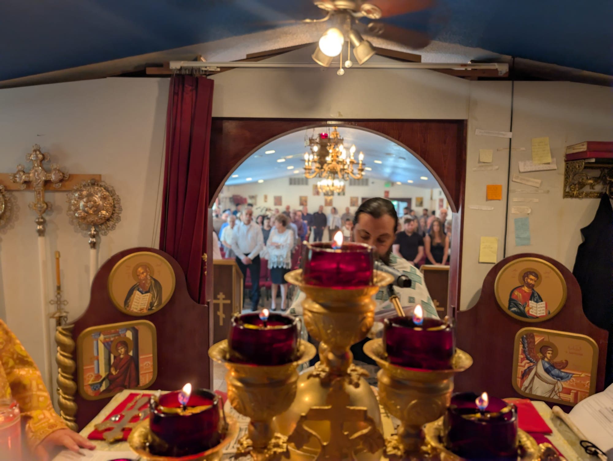 Candles before the royal doors of the iconostasis